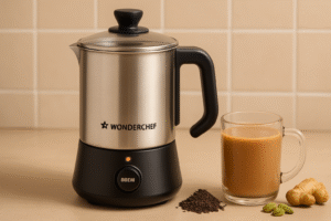 A modern Wonderchef Chai Magic Automatic Tea Maker on a kitchen counter, brewing tea, with a cup beside it, set against a warm, cozy background.