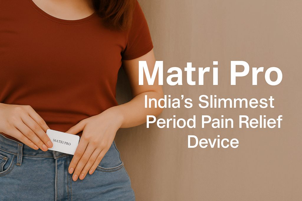 Woman wearing a rust-colored t-shirt and blue jeans holding a slim Matri Pro period pain relief device near her abdomen, with beige background and bold white text reading “Matri Pro – India’s Slimmest Period Pain Relief Device.”